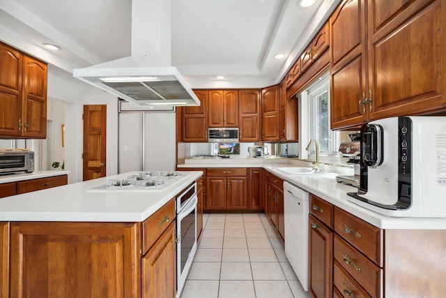 kitchen featuring island range hood, white appliances, brown cabinets, light countertops, and recessed lighting