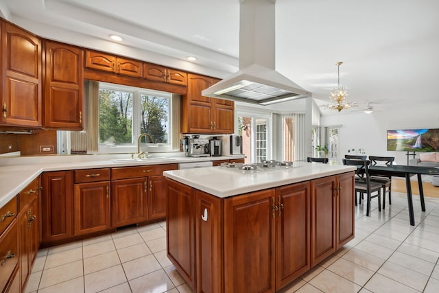 kitchen with island exhaust hood, a sink, white cooktop, light tile patterned flooring, and light countertops