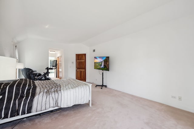 carpeted bedroom featuring vaulted ceiling and baseboards