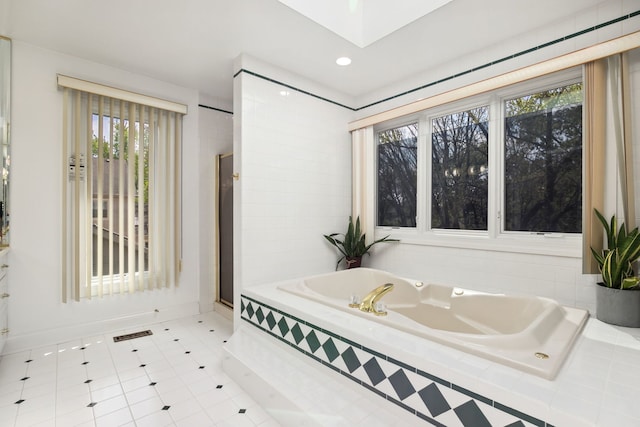 bathroom with a garden tub, a shower stall, tile patterned floors, recessed lighting, and baseboards