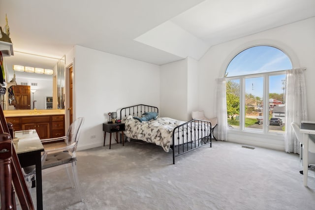 carpeted bedroom featuring lofted ceiling