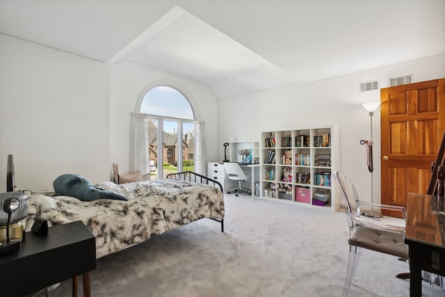 carpeted bedroom featuring an office area and vaulted ceiling