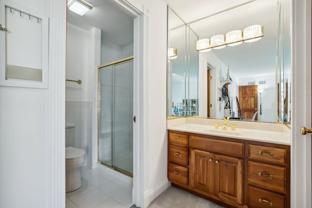 full bath featuring toilet, a shower stall, vanity, and tile patterned flooring