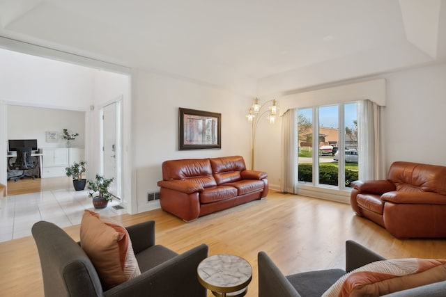 living room with a chandelier and light wood-style flooring
