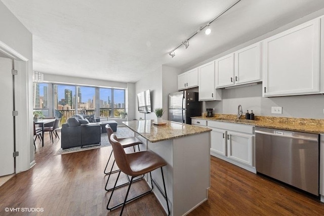1717 S Prairie Ave Unit 1902, Chicago, IL 60616 - kitchen with appliances with stainless steel finishes, a kitchen breakfast bar, white cabinetry, and light stone countertops