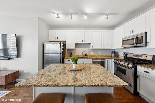 1717 S Prairie Ave Unit 1902, Chicago, IL 60616 - kitchen featuring appliances with stainless steel finishes, dark wood-style floors, light stone counters, and white cabinets