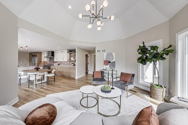 2128 Scotch Pine Ln, Northbrook, IL 60062 - living room with light wood finished floors, a chandelier, baseboards, a towering ceiling, and recessed lighting