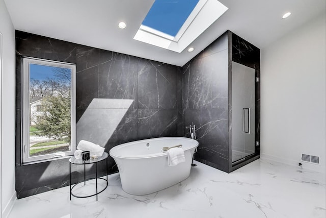2128 Scotch Pine Ln, Northbrook, IL 60062 - full bathroom with marble tiled flooring, a skylight, tile walls, recessed lighting, and a freestanding tub