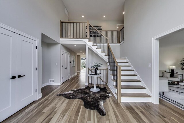 2128 Scotch Pine Ln, Northbrook, IL 60062 - foyer featuring a high ceiling, wood finished floors, stairs, and baseboards