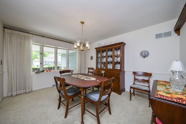 1405 N W St, Naperville, IL 60563 - dining space featuring a chandelier, light colored carpet, and baseboards