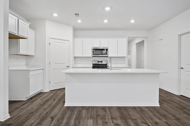 2601 Harnish Dr, Algonquin, IL 60102 - kitchen featuring stainless steel appliances, dark wood-type flooring, a center island with sink, light countertops, and recessed lighting