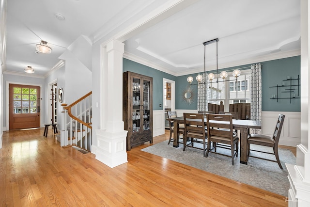 4617 Linscott Ave, Downers Grove, IL 60515 - dining room with light wood-style flooring, ornamental molding, a chandelier, stairway, and ornate columns