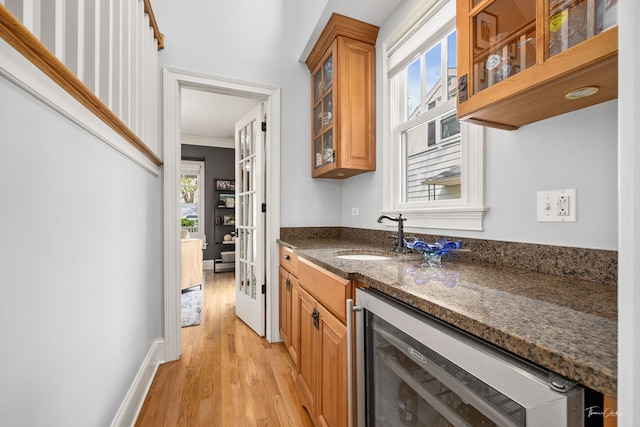 4617 Linscott Ave, Downers Grove, IL 60515 - kitchen with wine cooler, light wood-type flooring, dark stone countertops, brown cabinets, and glass insert cabinets