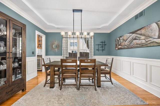 4617 Linscott Ave, Downers Grove, IL 60515 - dining area with a raised ceiling, a wainscoted wall, beverage cooler, a chandelier, and crown molding
