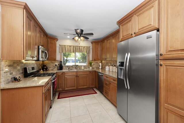 5400 Midlothian Tpke, Crestwood, IL 60418 - kitchen featuring appliances with stainless steel finishes, a sink, backsplash, ceiling fan, and light stone counters