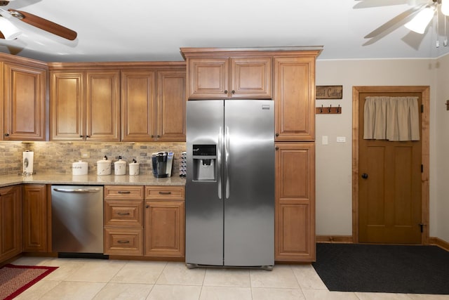 5400 Midlothian Tpke, Crestwood, IL 60418 - kitchen with appliances with stainless steel finishes, a ceiling fan, brown cabinetry, light tile patterned flooring, and light stone counters