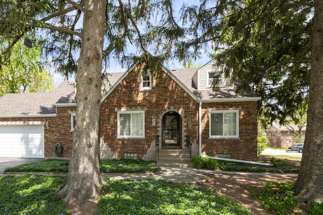 5400 Midlothian Tpke, Crestwood, IL 60418 - tudor home featuring brick siding, an attached garage, a shingled roof, and concrete driveway
