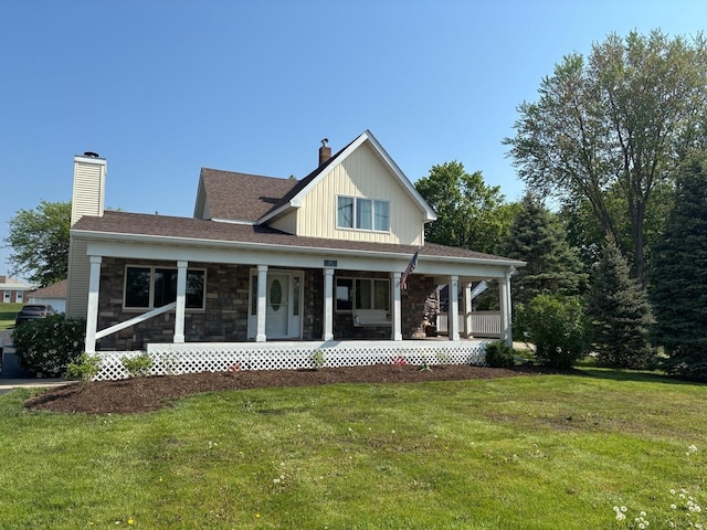 2112 Church St, Johnsburg, IL 60051 - view of front facade featuring a chimney, a front yard, stone siding, and covered porch