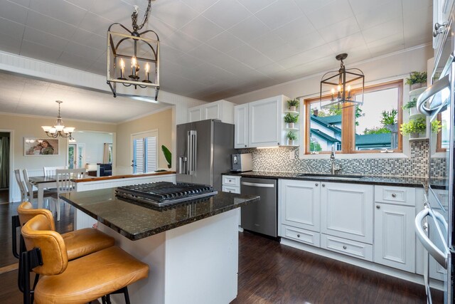 2112 Church St, Johnsburg, IL 60051 - kitchen featuring a chandelier, stainless steel appliances, open shelves, a sink, and white cabinets