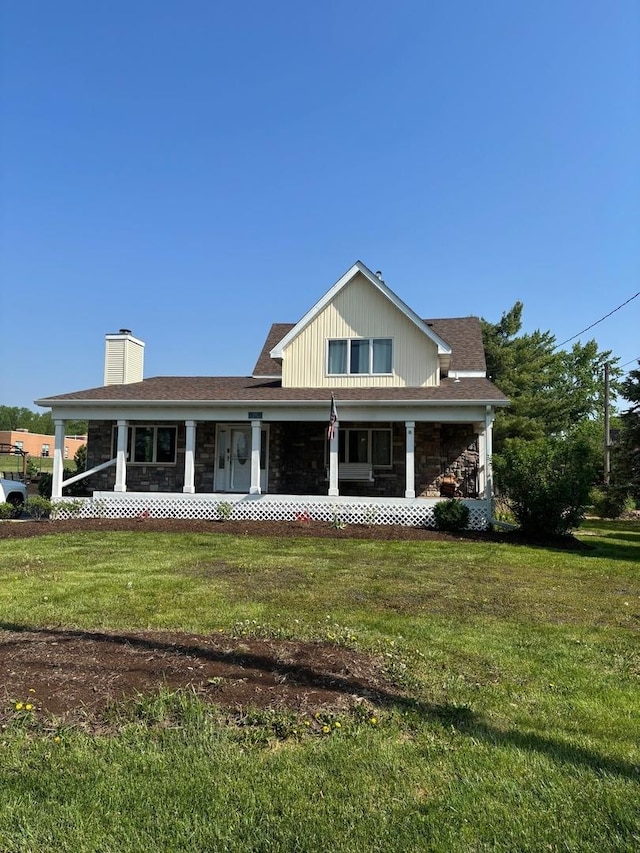 2112 Church St, Johnsburg, IL 60051 - view of front facade featuring a chimney, a porch, a front lawn, and stone siding