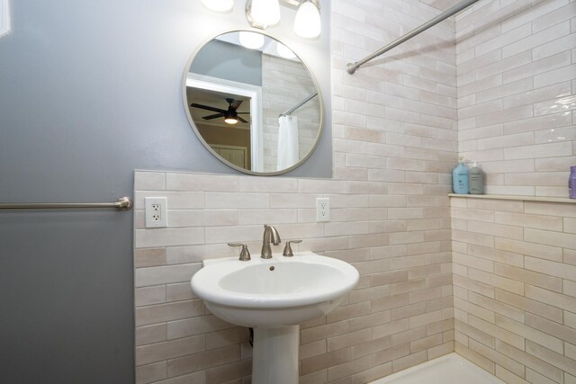 2112 Church St, Johnsburg, IL 60051 - bathroom with a tile shower, a ceiling fan, and tasteful backsplash