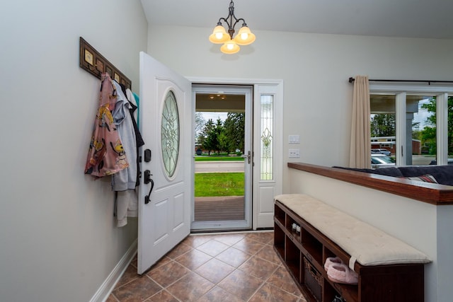 2112 Church St, Johnsburg, IL 60051 - foyer entrance with a chandelier, dark tile patterned flooring, and baseboards