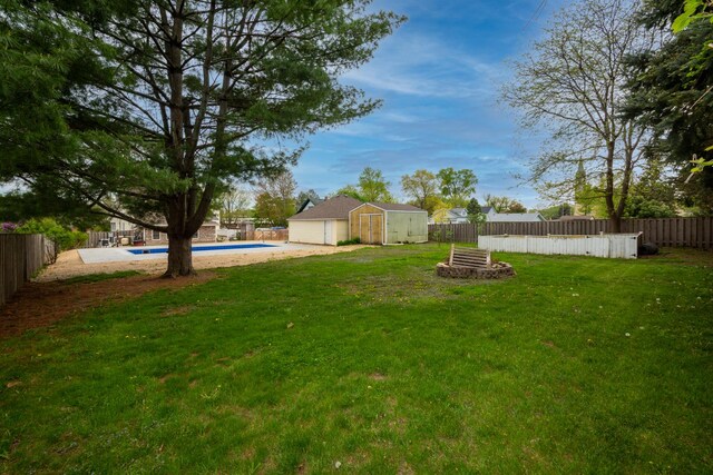 2112 Church St, Johnsburg, IL 60051 - view of yard featuring a fire pit, a storage unit, and an outbuilding