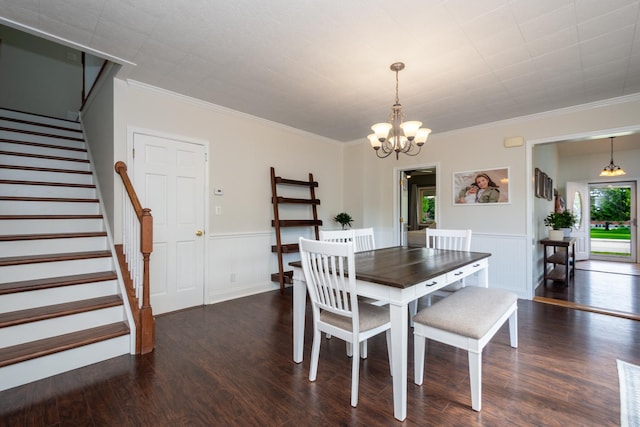 2112 Church St, Johnsburg, IL 60051 - dining space featuring a chandelier, stairs, wood finished floors, a wainscoted wall, and crown molding
