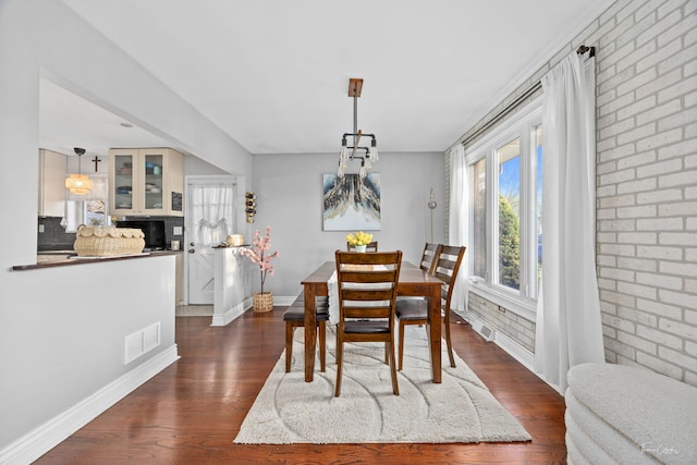 8327 S 78th Ave, Bridgeview, IL 60455 - dining area with dark wood finished floors, baseboards, and brick wall