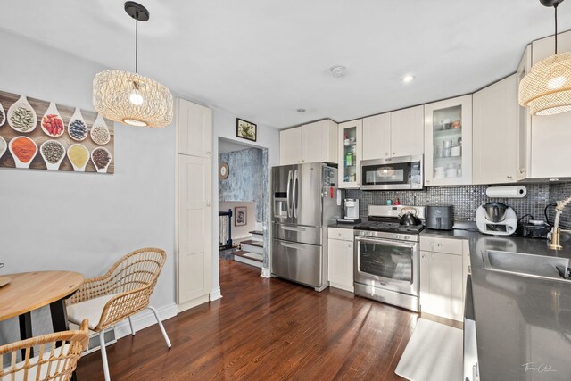 8327 S 78th Ave, Bridgeview, IL 60455 - kitchen with stainless steel appliances, a sink, dark countertops, dark wood finished floors, and backsplash