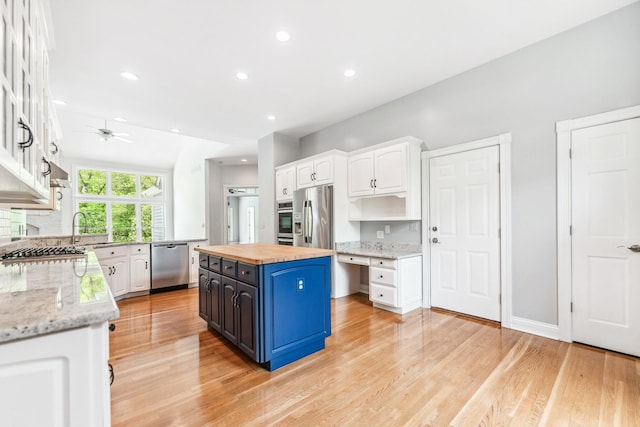 3302 Greenwood Ln, Saint Charles, IL 60175 - kitchen featuring appliances with stainless steel finishes, butcher block counters, white cabinets, blue cabinetry, and a ceiling fan