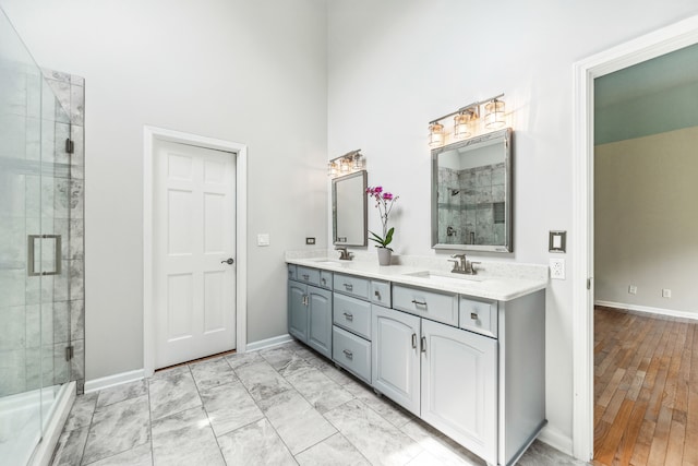 3302 Greenwood Ln, Saint Charles, IL 60175 - full bath with a shower stall, baseboards, a towering ceiling, and double vanity