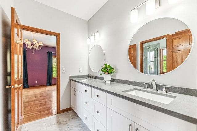 3302 Greenwood Ln, Saint Charles, IL 60175 - full bathroom with marble look tiles, a chandelier, double vanity, a shower with door, and baseboards