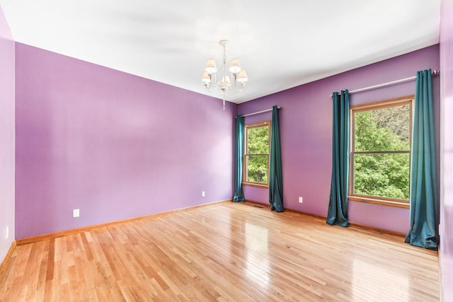 3302 Greenwood Ln, Saint Charles, IL 60175 - spare room with a chandelier, light wood-style flooring, and baseboards
