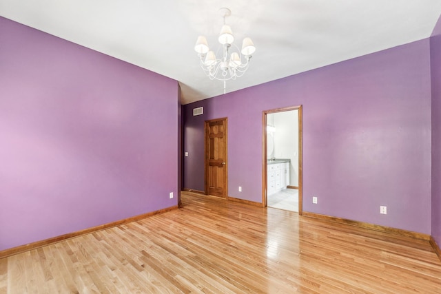 3302 Greenwood Ln, Saint Charles, IL 60175 - empty room with a chandelier, wood finished floors, and baseboards
