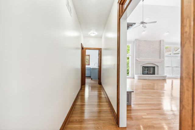 3302 Greenwood Ln, Saint Charles, IL 60175 - hallway featuring light wood-style floors, baseboards, and a sink