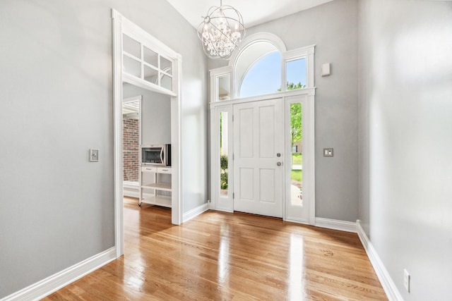 3302 Greenwood Ln, Saint Charles, IL 60175 - entrance foyer with a chandelier, light wood-style flooring, baseboards, and a high ceiling