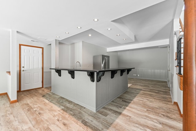 3302 Greenwood Ln, Saint Charles, IL 60175 - kitchen with freestanding refrigerator, a kitchen bar, light wood-type flooring, wainscoting, and recessed lighting