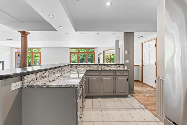 3302 Greenwood Ln, Saint Charles, IL 60175 - kitchen with gray cabinetry, recessed lighting, freestanding refrigerator, ornate columns, and light tile patterned floors