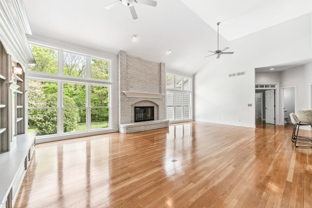 3302 Greenwood Ln, Saint Charles, IL 60175 - unfurnished living room with a ceiling fan, high vaulted ceiling, light wood-style flooring, a fireplace, and baseboards