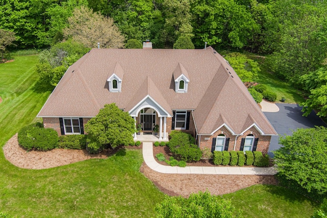 3302 Greenwood Ln, Saint Charles, IL 60175 - cape cod-style house with brick siding, a chimney, and a front lawn