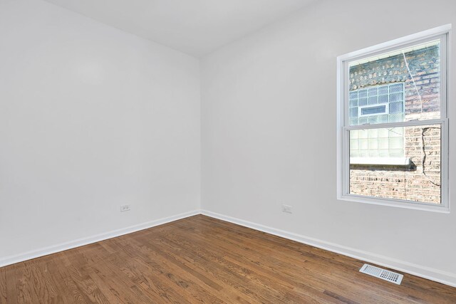 7709 S Eberhart Ave, Chicago, IL 60619 - unfurnished room with dark wood-type flooring and baseboards