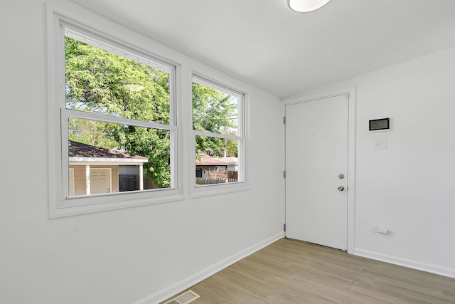 7709 S Eberhart Ave, Chicago, IL 60619 - unfurnished room with baseboards and light wood-style flooring