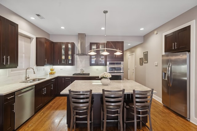 1242 W Jackson Blvd Unit 2W, Chicago, IL 60607 - kitchen with appliances with stainless steel finishes, wall chimney range hood, a sink, decorative backsplash, and recessed lighting