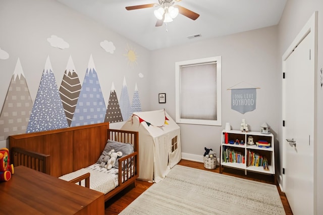 1242 W Jackson Blvd Unit 2W, Chicago, IL 60607 - bedroom featuring wood finished floors, baseboards, ceiling fan, and a nursery area