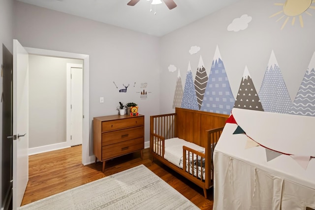 1242 W Jackson Blvd Unit 2W, Chicago, IL 60607 - bedroom with wood finished floors, a crib, baseboards, and a ceiling fan