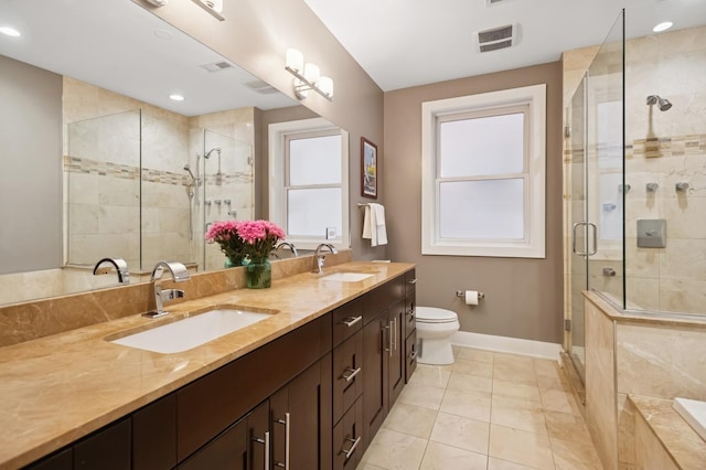1242 W Jackson Blvd Unit 2W, Chicago, IL 60607 - bathroom featuring baseboards, double vanity, a stall shower, toilet, and a bathtub