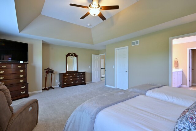 13464 Skyline Dr, Plainfield, IL 60585 - bedroom featuring a raised ceiling, light carpet, baseboards, ceiling fan, and ensuite bathroom