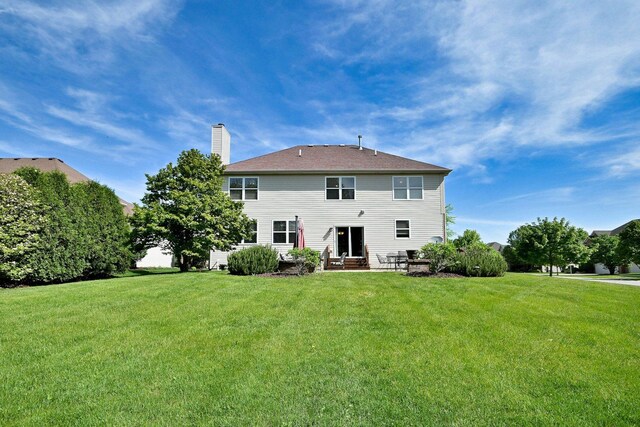 13464 Skyline Dr, Plainfield, IL 60585 - back of house featuring a chimney, a yard, and a patio area