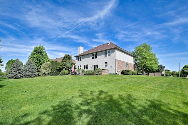 13464 Skyline Dr, Plainfield, IL 60585 - rear view of house featuring a chimney, a lawn, and brick siding